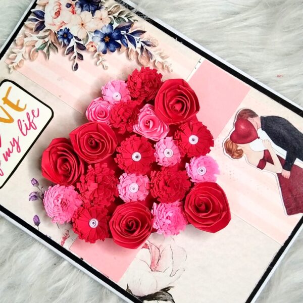 Quilled red flowers in heart greeting card